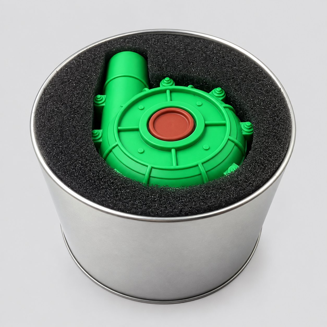 A green plastic mine-shaped novelty USB flash drive fitted inside a round silver tin gift box with foam insert, illustrating premium packaging and a fully custom-mold novelty shape for a high-end promotional order.